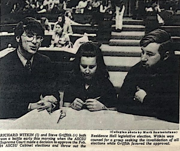 A grainy, black and white photo of three college students sitting at a table.