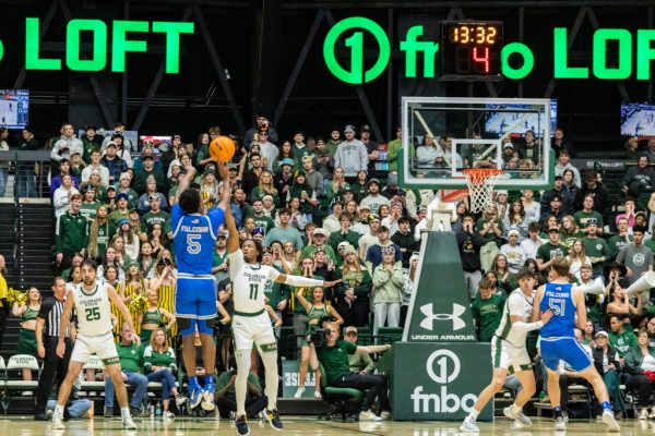 Keshawn Williams (11) contests a three-pointer from the Air Force Academy's Ethan Taylor (5) during Colorado State University men's basketball's game Jan. 28. CSU won 79-58.