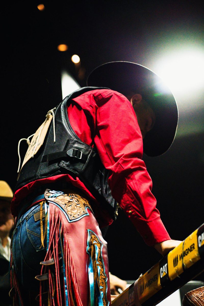 Contestant Tag Moses prepares for his saddle bronc ride at the National Western Stock Show Bracket 4 Round 1 Pro Rodeo in Denver Sunday, Jan. 19. Moses was competing for a spot in the semi-finals, but ultimately did not earn scores high enough to advance. 