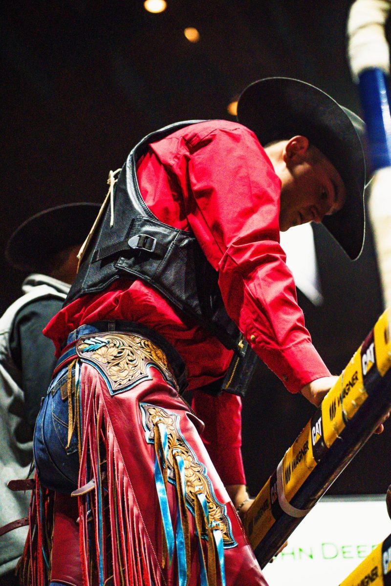 A man wearing red ornate rodeo pants