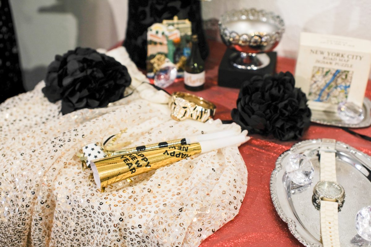 A table with celebratory items and party poppers make up the January 1st display that provides information and context for understanding the origins of cultural New Year's traditions Jan. 24. This is one display at Ringing in the New: New Year Traditions Around the World, an exhibit at the Global Village Museum of Arts and Cultures in Fort Collins.