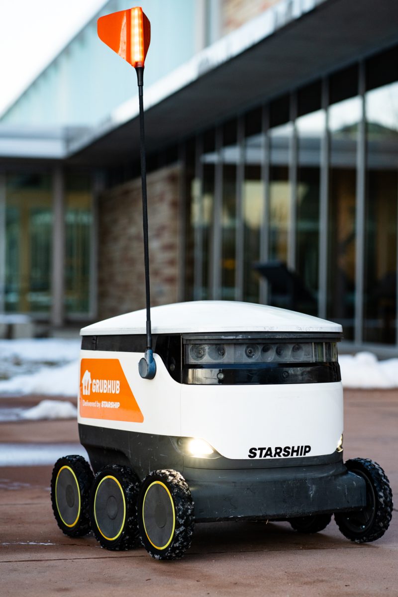 A Starship Technologies food delivery robot powers on and makes its way down a ramp outside the Lory Student Center Jan. 27.