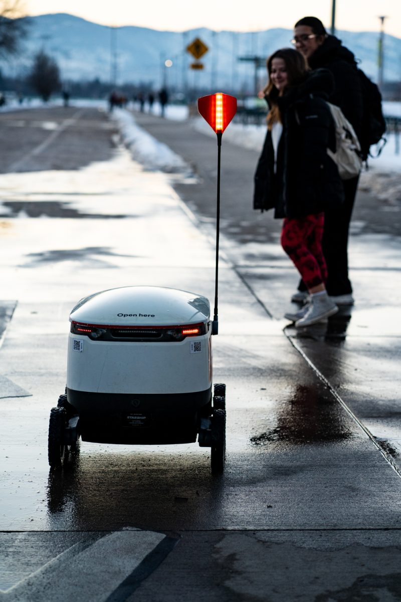 A Starship food delivery robot drives down a campus walking path on its way to deliver food Jan. 27.