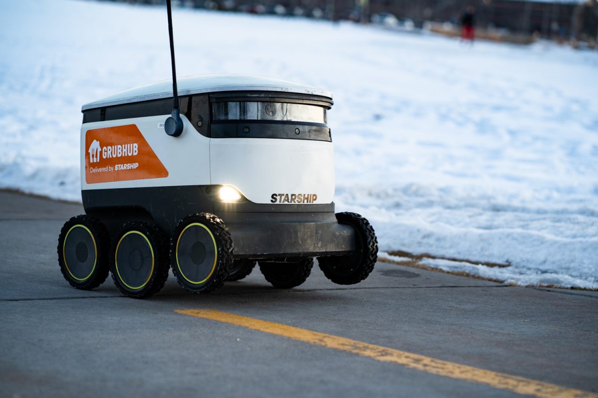 A Starship food delivery robot drives down a campus walking path on its way to deliver food Jan. 27.