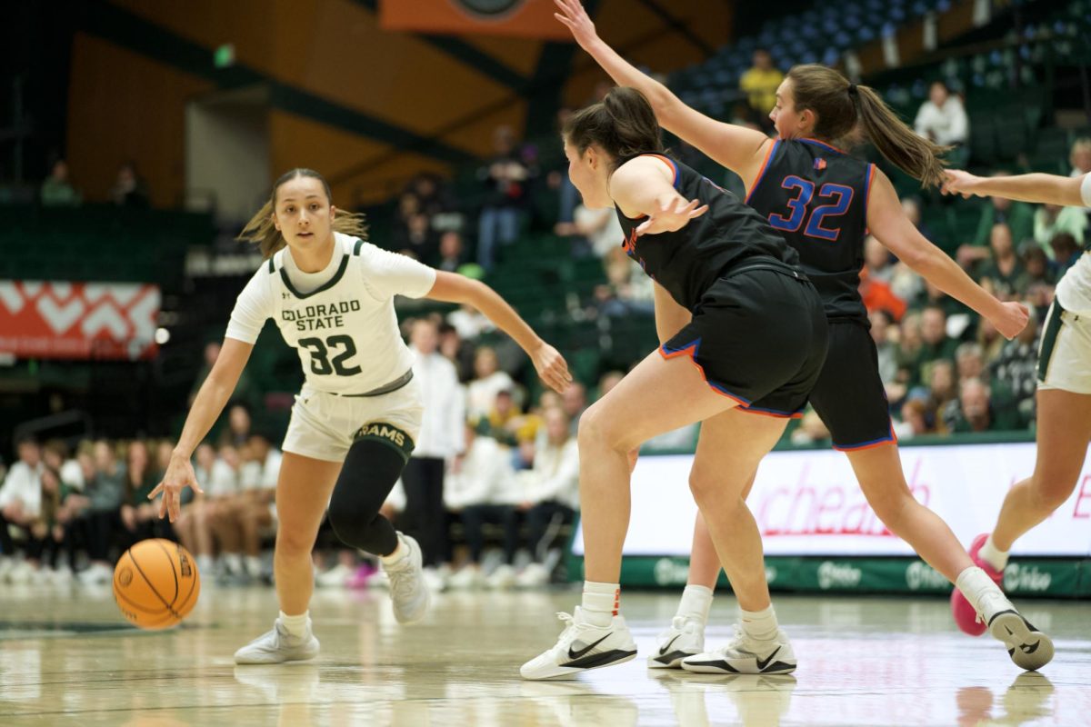 Hannah Simental (32) dribbles around Boise State players and scores a point for the Colorado State University Women's Basketball Team on Tuesday, 1/21. The Colorado State Rams took the win with an end score of 79-70. 