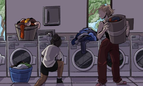 A student and a ram take their laundry out of the machines. On top of the second right-most laundry machine is a pile of clothes.