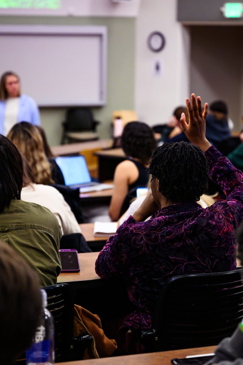 A student in Psychology of Human Sexuality in Pathology 101 raises their hand to answer a question asked by Professor Sara Garvey Feb. 7.