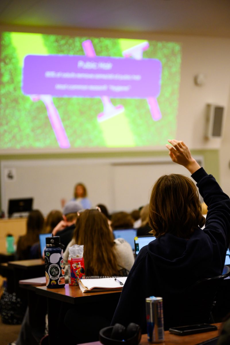 A student in Psychology of Human Sexuality in Pathology 101 raises their hand to answer a question asked by Professor Sara Garvey Feb. 7.