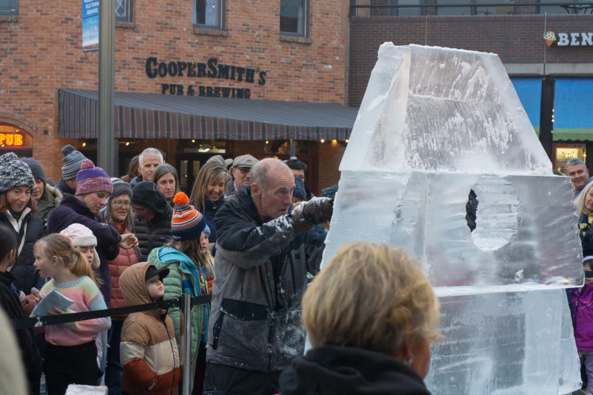A person using a chainsaw to cut into ice.