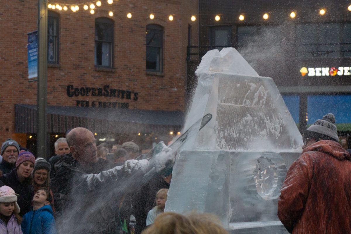 A person using a chainsaw to cut into ice.