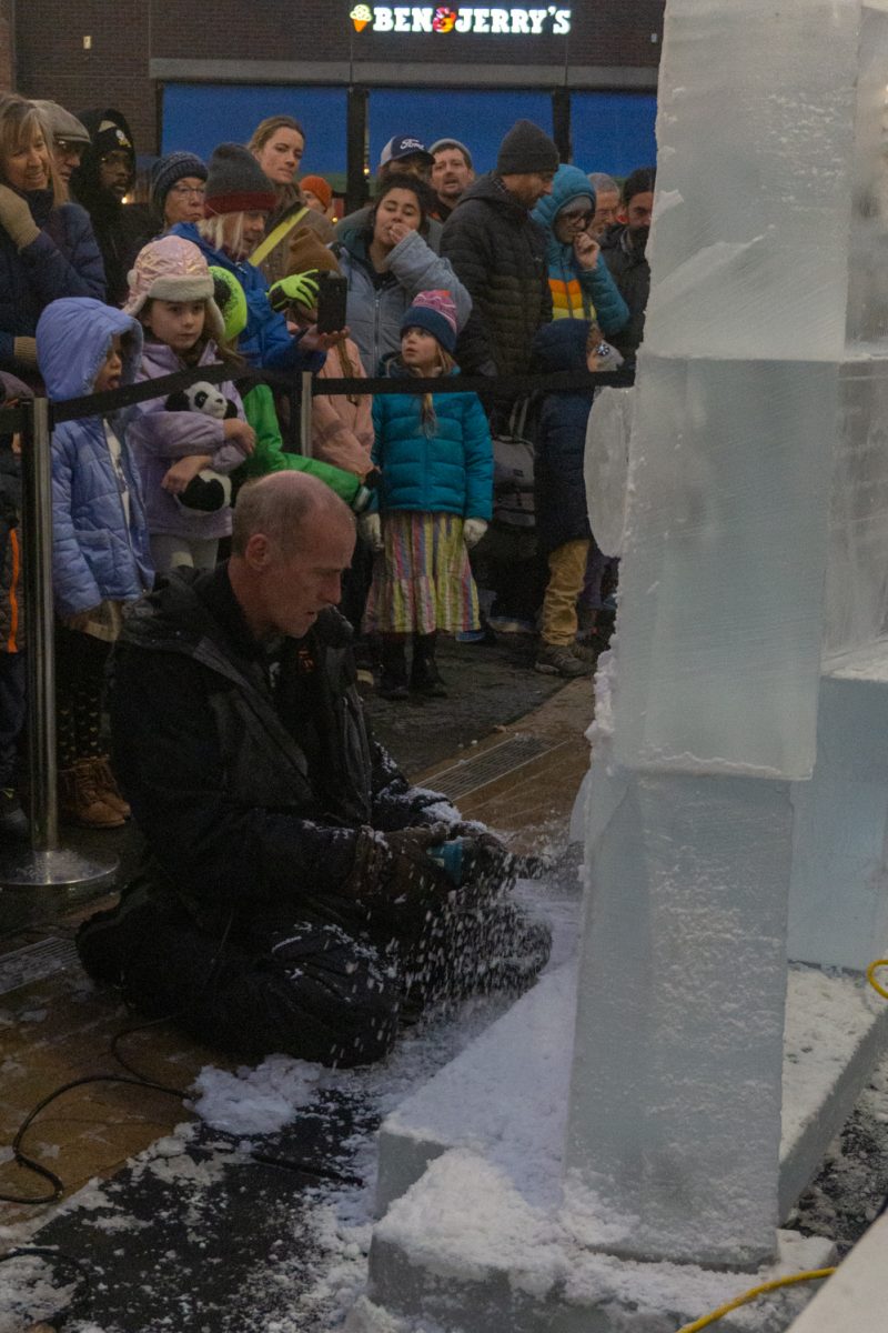 A person using a chainsaw to cut into ice.