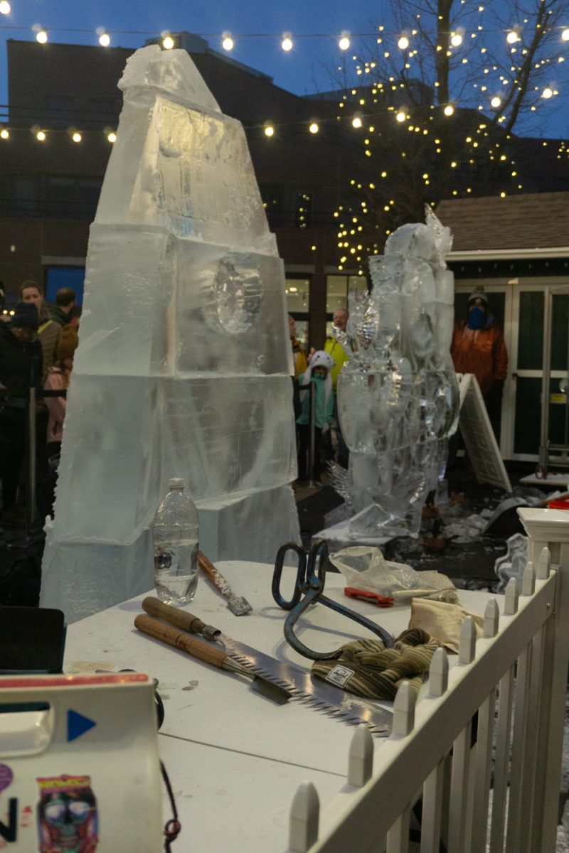 Tools sit on a table in front of two ice sculptures.