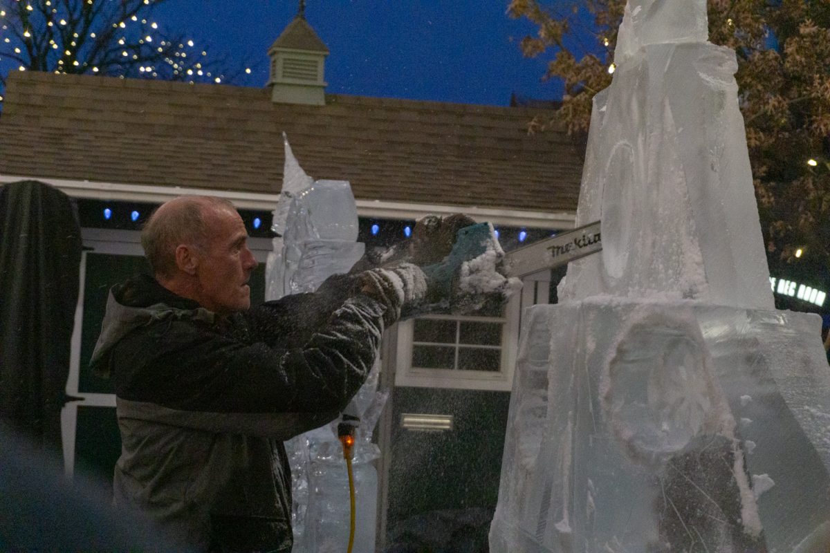 A person using a chainsaw to cut into ice.