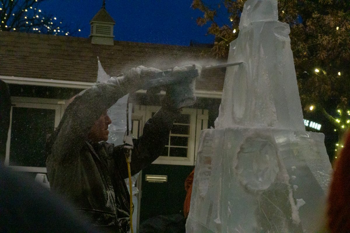 A person using a chainsaw to cut into ice.
