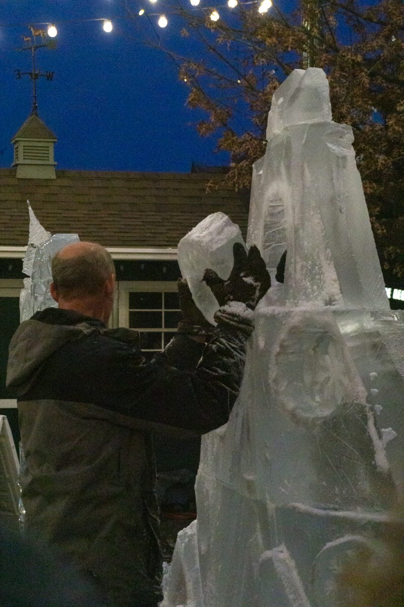 A person puts a chunk of ice onto a larger piece.