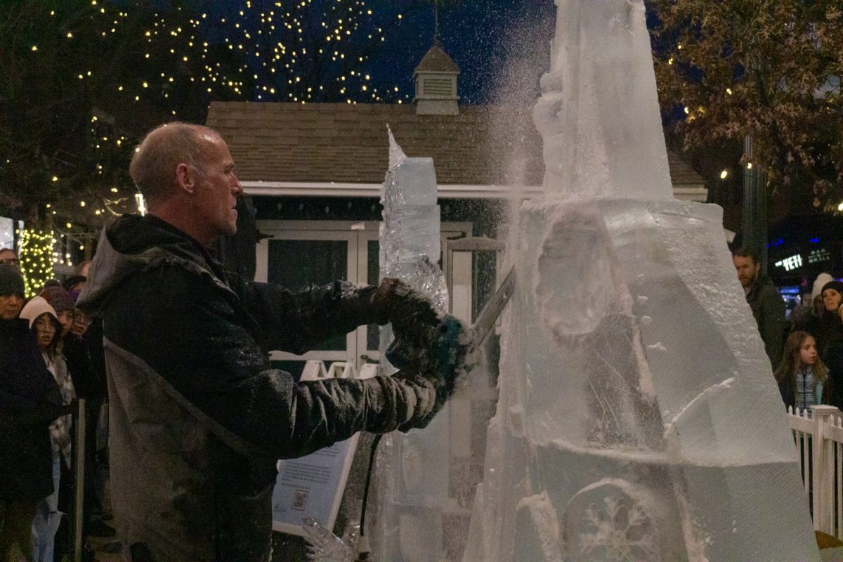 A person using a chainsaw to cut into ice.