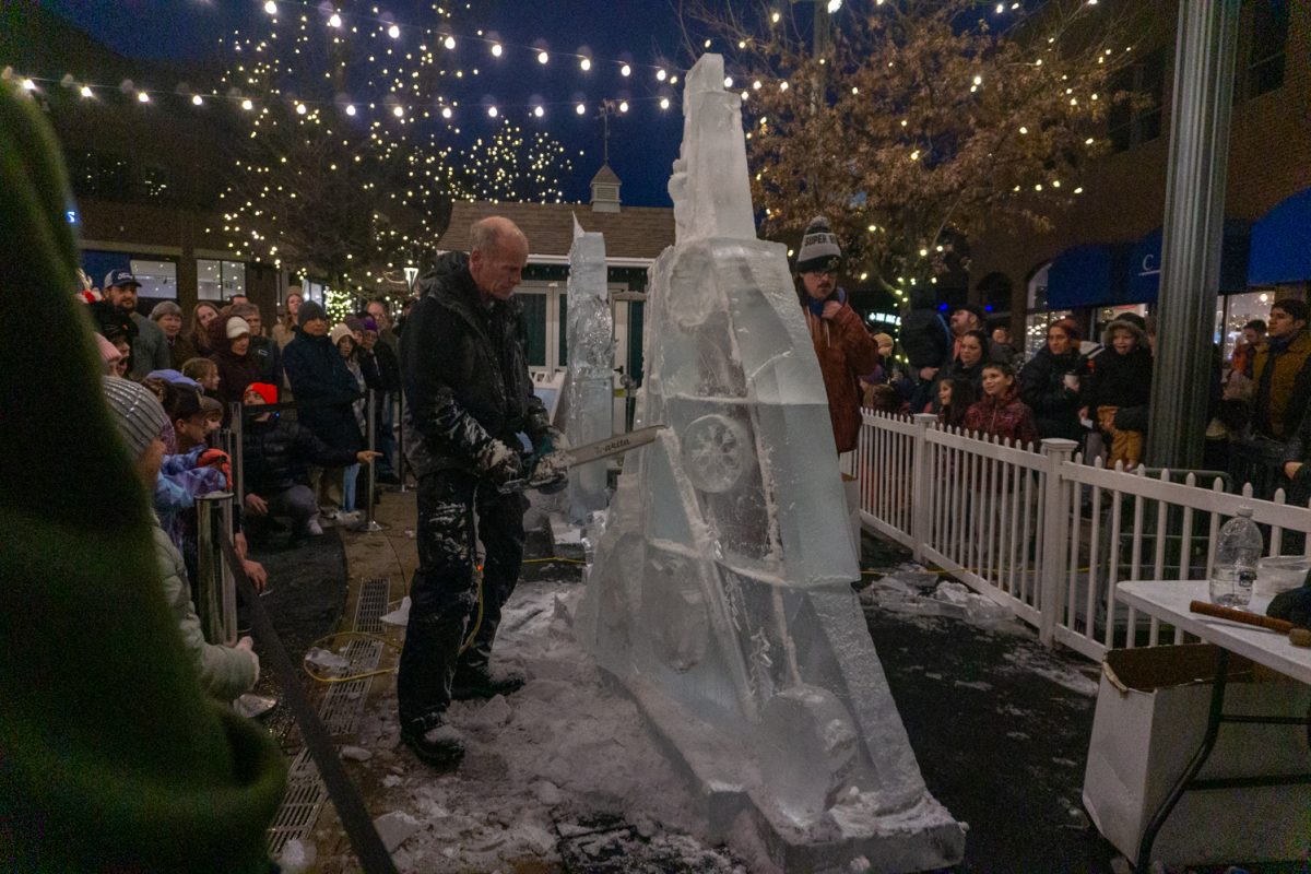 A person using a chainsaw to cut into ice.