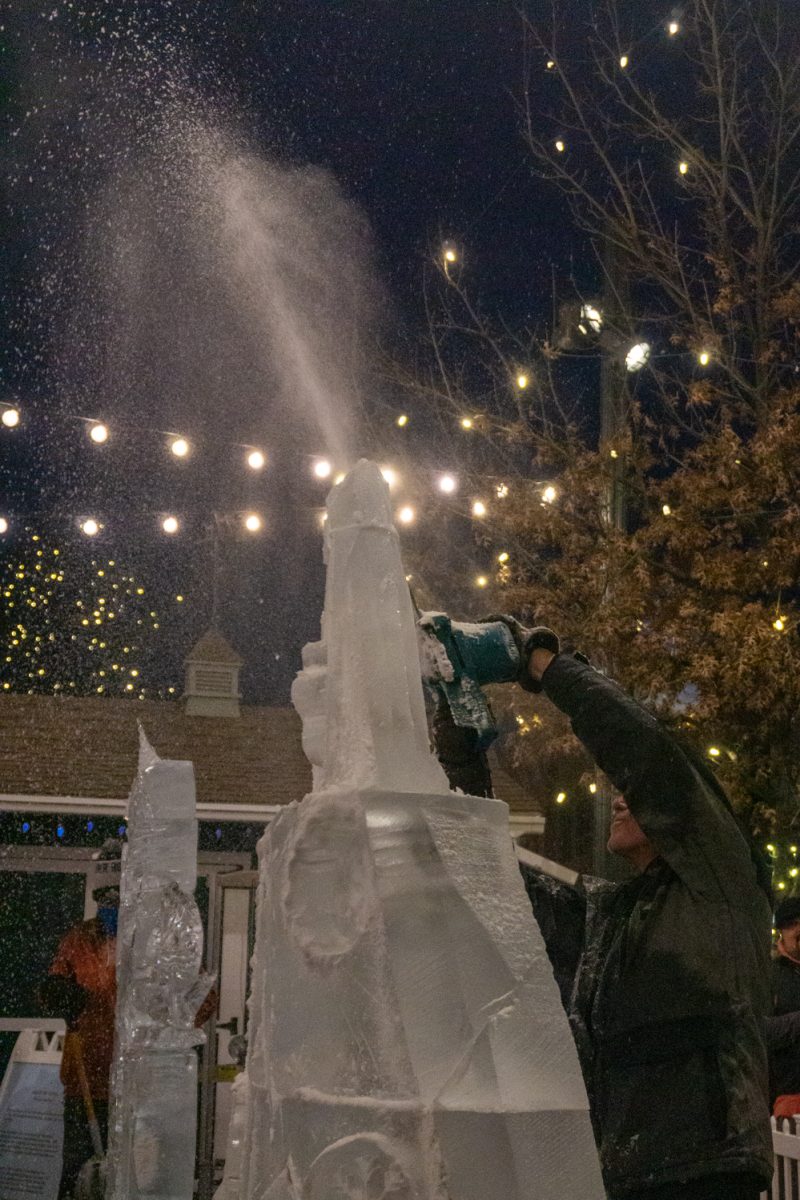A person using a chainsaw to cut into ice.