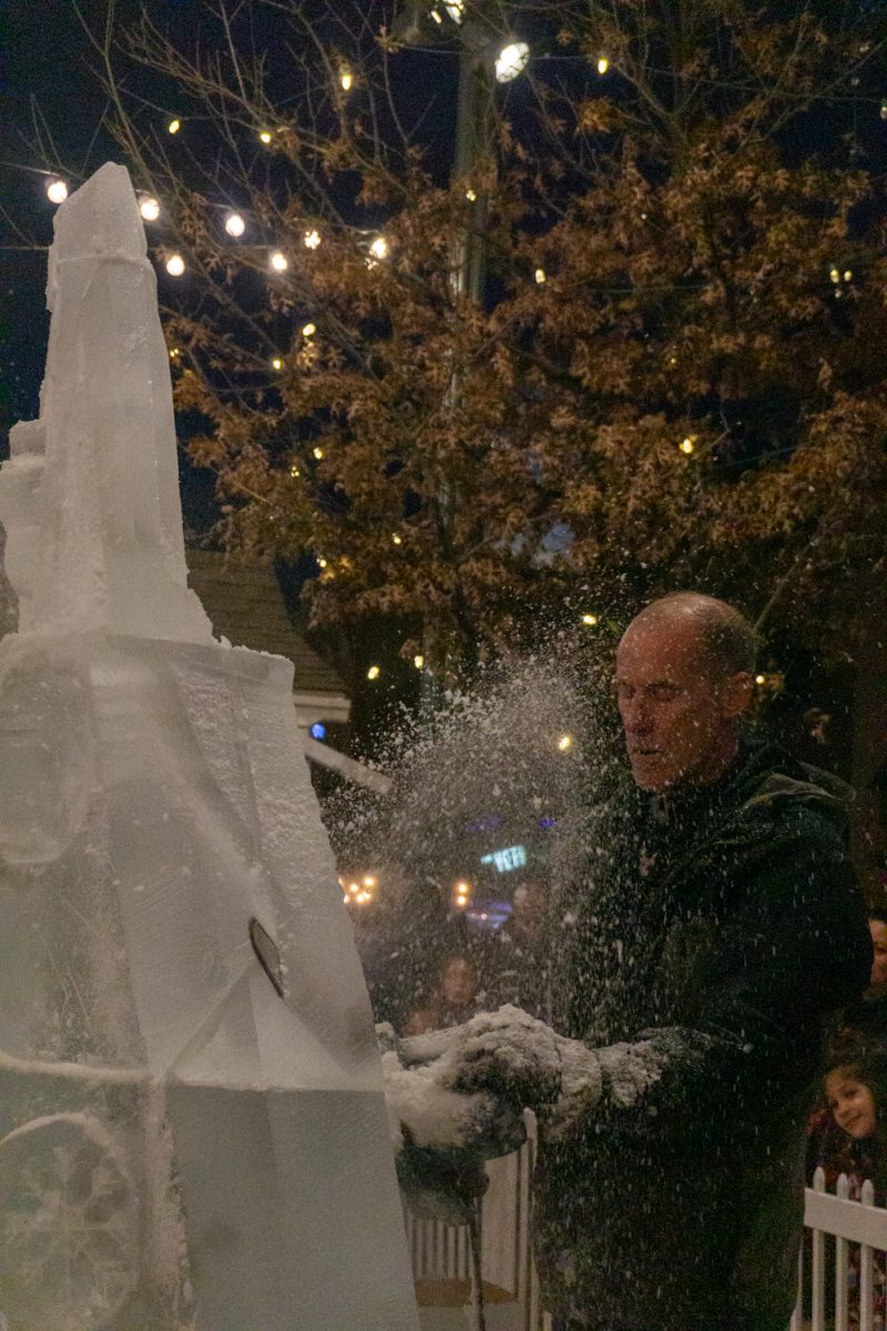A person using a chainsaw to cut into ice.