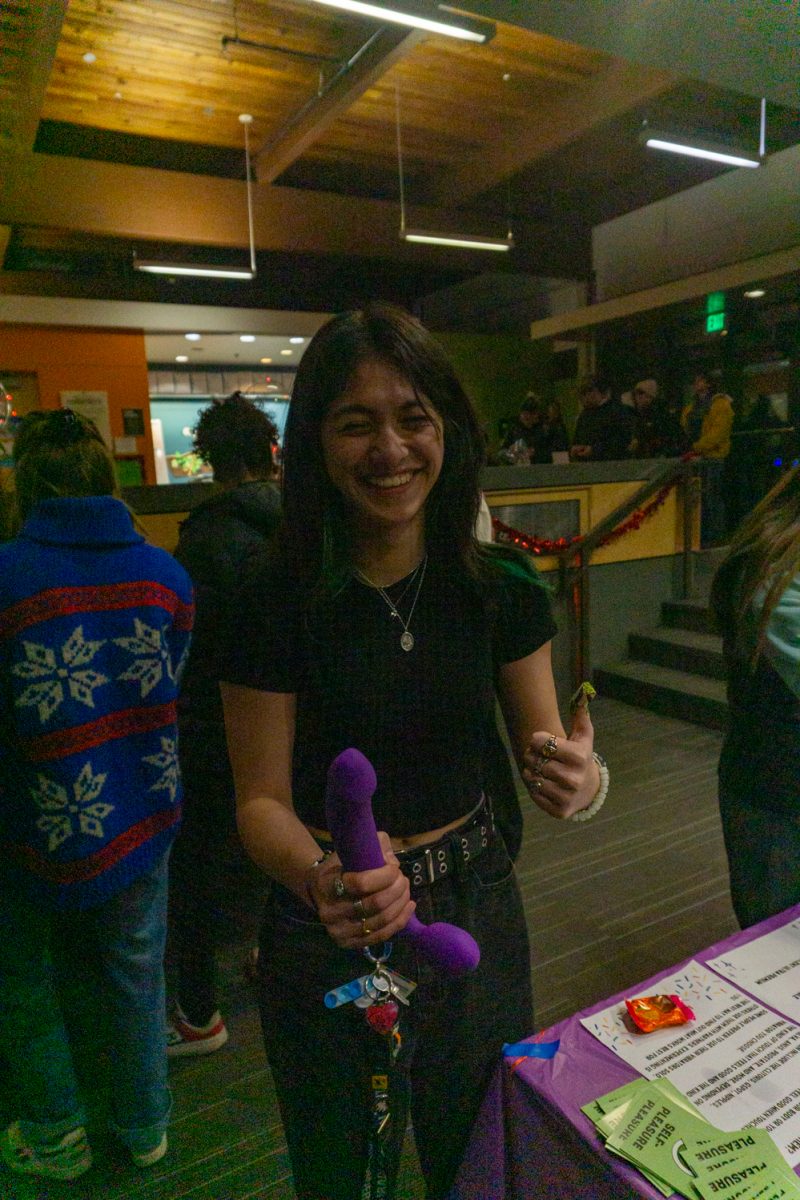 A person is holding a sex toy.