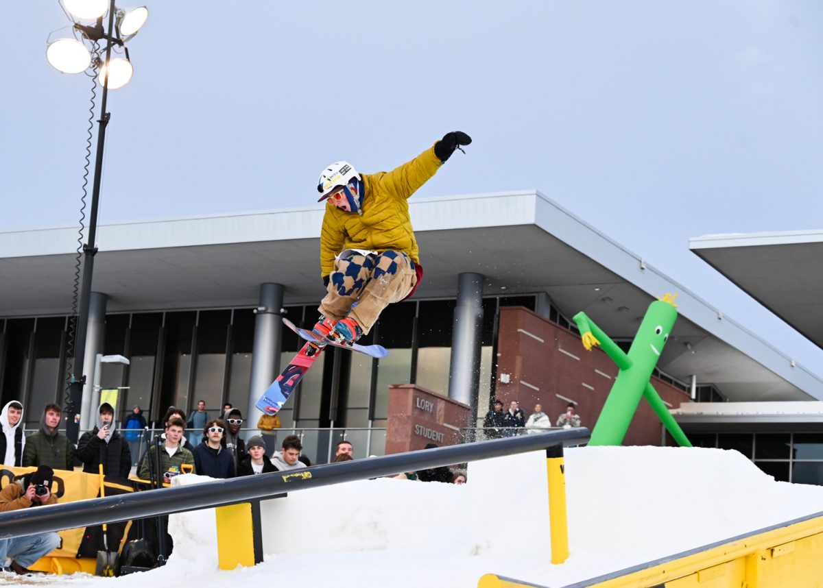 Kenny Schlosser jumps onto the rail while skiing on telemark skis — a ski with free heels on the binding — during RailJam, which was held on the Lory Student Center West Lawn Feb. 13.