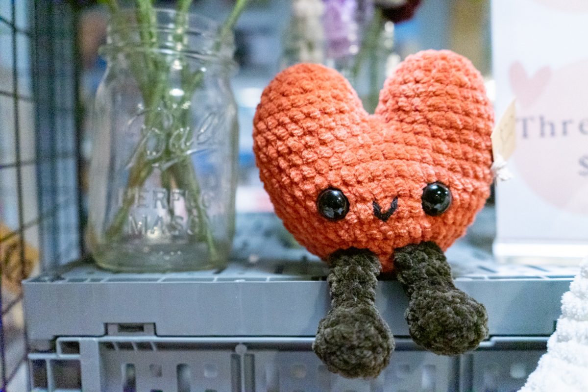 A small, stuffed crocheted character in the shape of a heart sits on a shelf for display Feb. 14. Anya Marie, owner of Starry Cynders, sold many of their crocheted animals and characters at the Broken Hearts Club: an anti-Valentine's Day show at Mugs Old Town.