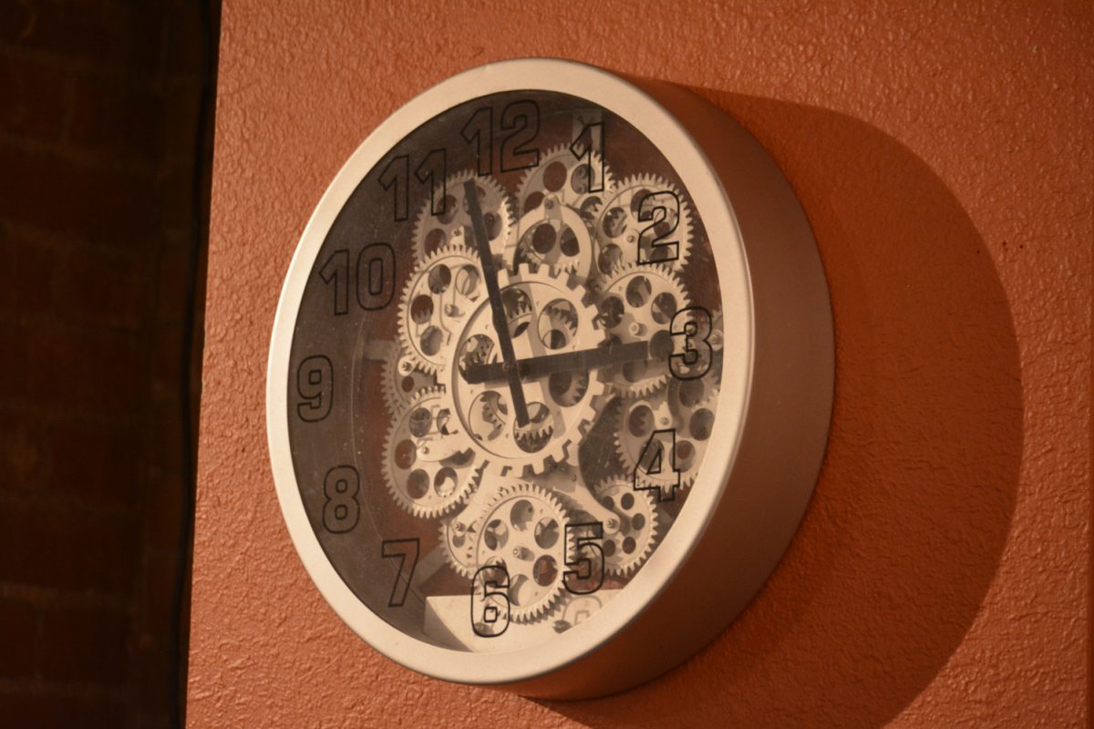 A metal clock with the gears showing