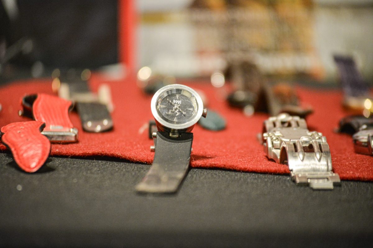 A collection of watches on a red and black table