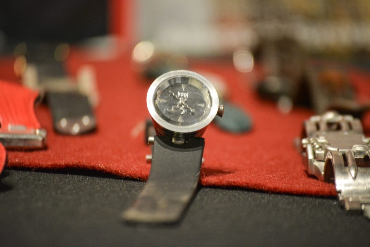 A watch on a black and red table