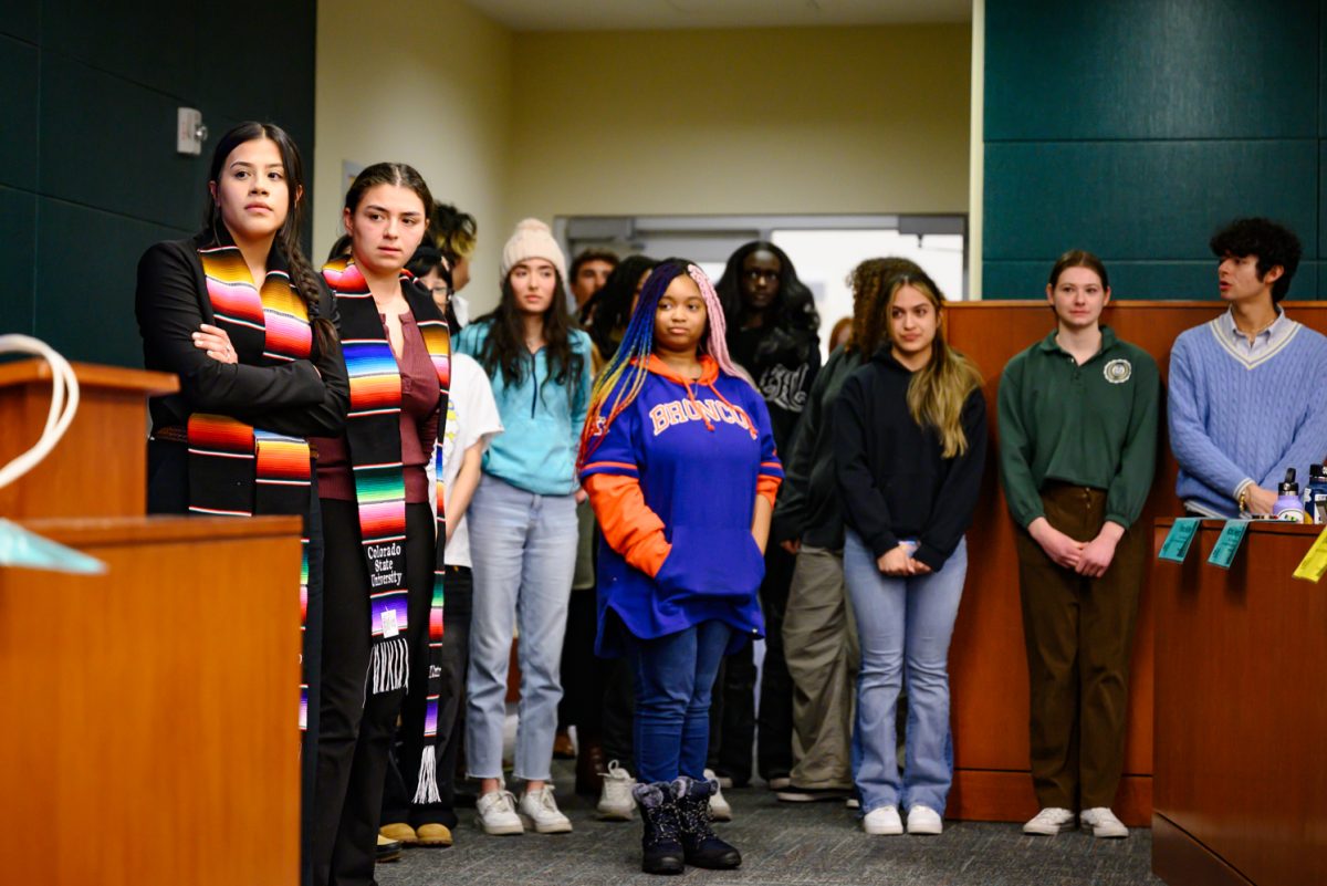 Senators of the Associated Students of Colorado State University representing different cultural resource centers stand in the front of the ASCSU senate chamber waiting to speak Feb. 19. Students and staff of various CRCs came to share their experiences on campus and the impact the centers have had on their lives as students.