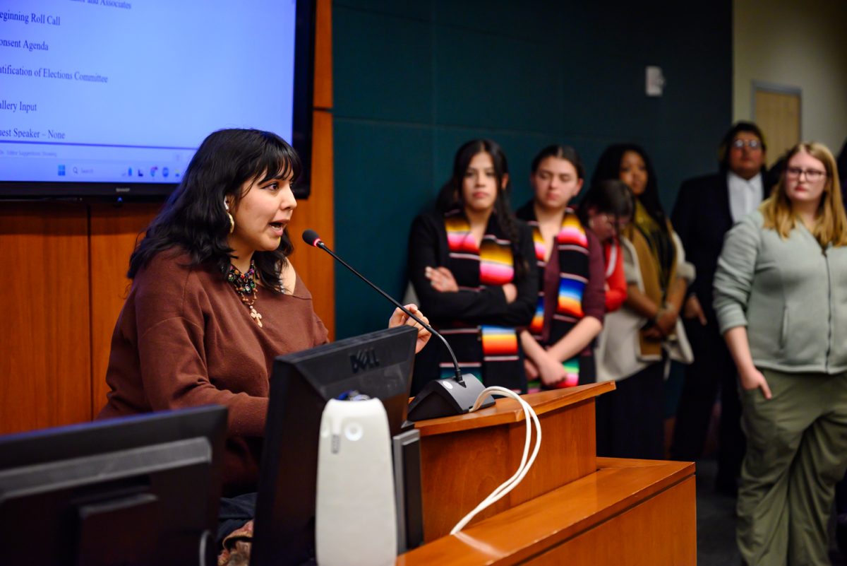 April Gonzalez speaks to the dozens of students gathered in the senate chamber of the Associated Students of Colorado State University Feb. 19. "We are asking you, as our senators, to use your power to go and pressure Amy Parsons to at least try to do something to protect us," she said.