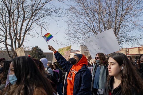 Colorado State University students hold flags and signs while protesting against the federal defunding of diversity, equity, inclusion and accessibility resources on campus. The CSU Student Coalition for DEIA held a protest on the Lory Student Center Plaza Feb. 19.