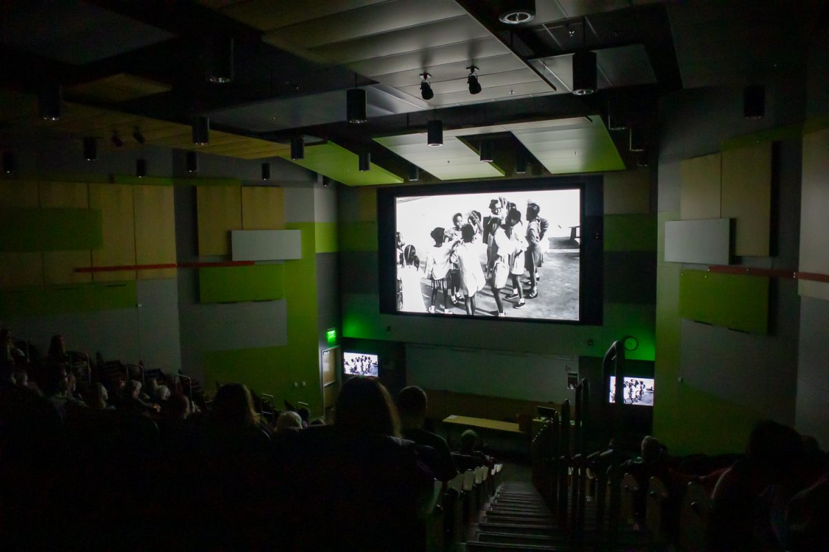 An audience watches the first short film of the night, "Black Girls Play: The Story Of Hand Games" Feb. 24. The Short Films on Black Brilliance event was held by the Black/African American Cultural Center with help from the ACT Human Rights Film Festival.