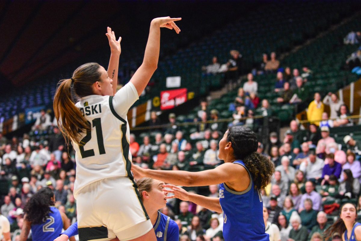 Player in green and white jersey throwing a free throw