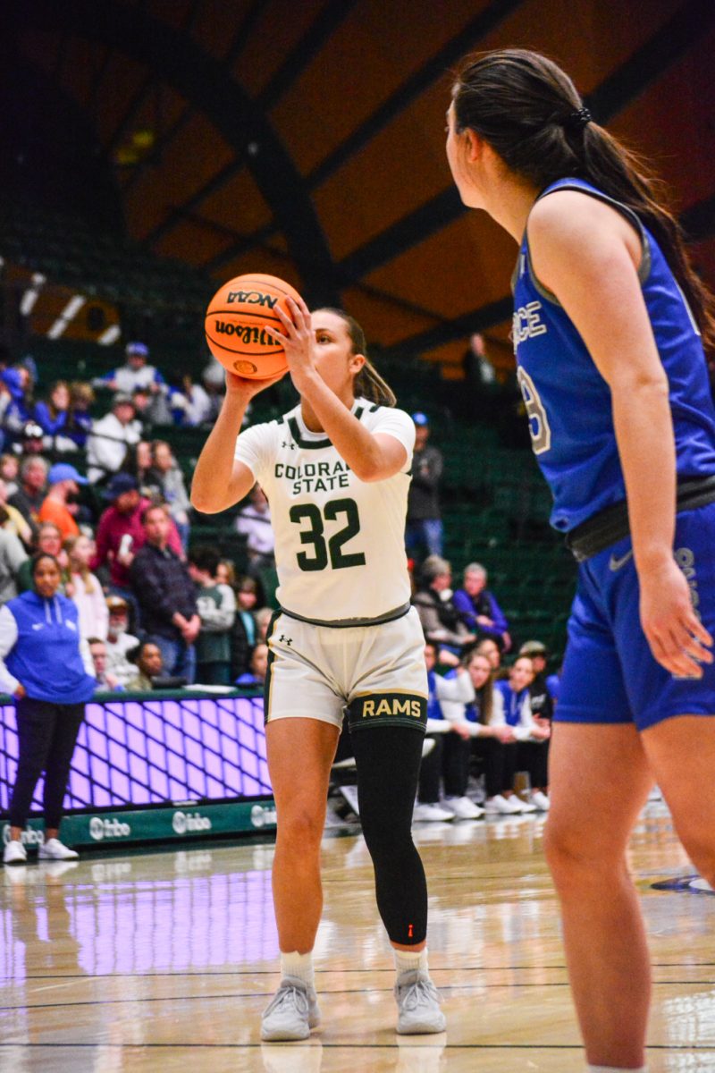Player in green and white jersey throwing a free throw