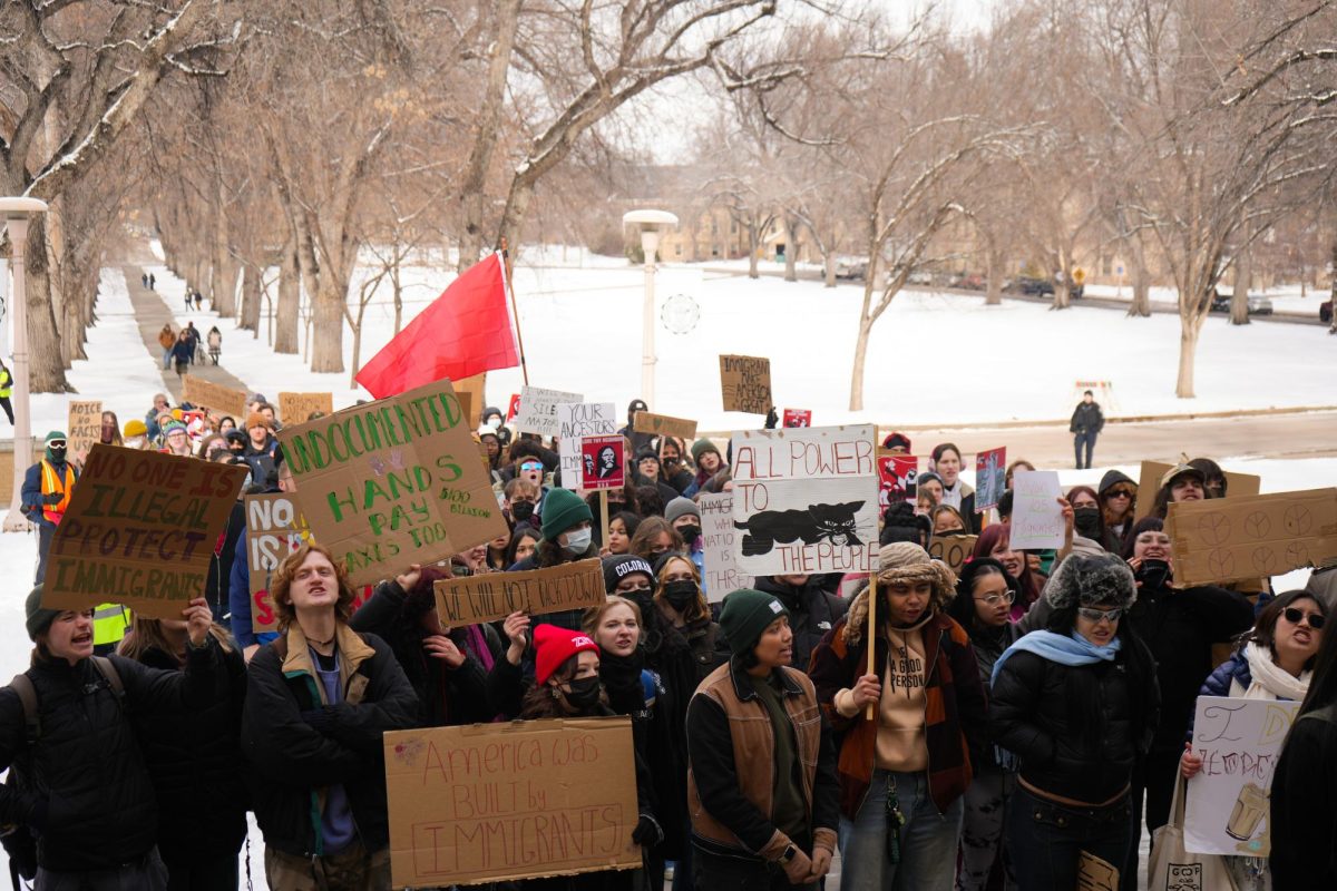 Students gathered infront of the steps of CSU's administration building in front of a snow-covered Oval chanting and hold signs such as "All power to the people," "America was built by immigrants," "Undocumented hands pay taxes, too," and "No one is illegal, protect immigrants."