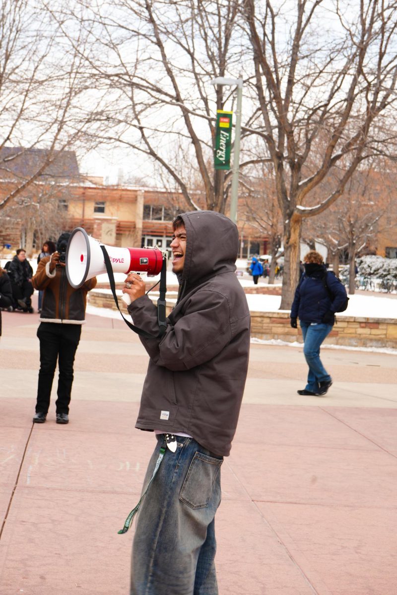 A student passionately gives a speech to the protest crowd in front of the Lory Student Center through a megaphone.