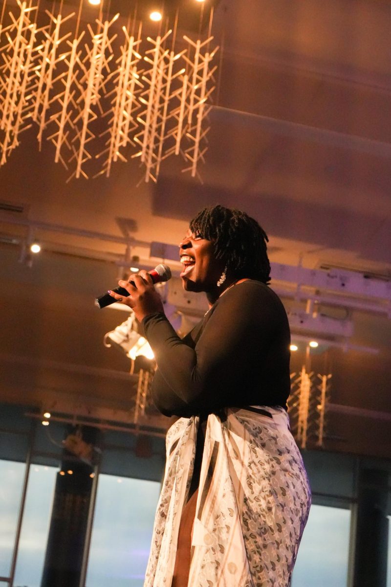A woman sings into a microphone.