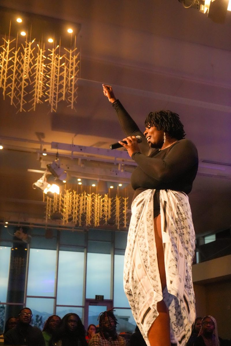A woman sings with her fist in the air.