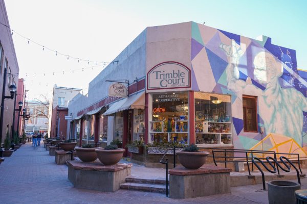 A building on a corner whose sign reads, "Trimble Court Artisans."