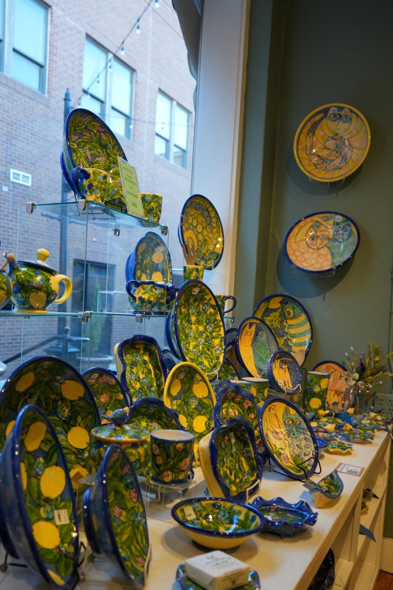 Colorful hand-crafted pottery sits on shelves at Trimble Court Artisans, located in Old Town Square in Fort Collins Feb. 27.