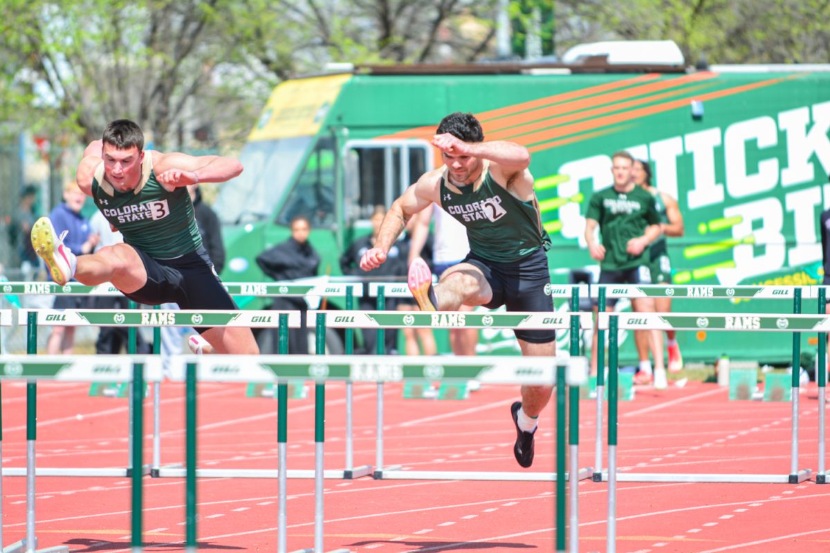 Zach Sell and Elijah Scott jumping over hurdles during their event March 29. This event was at the Jack Christiansen Memorial Track and Field.