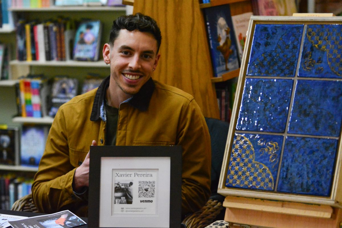 Image of artist showcasing his artwork.