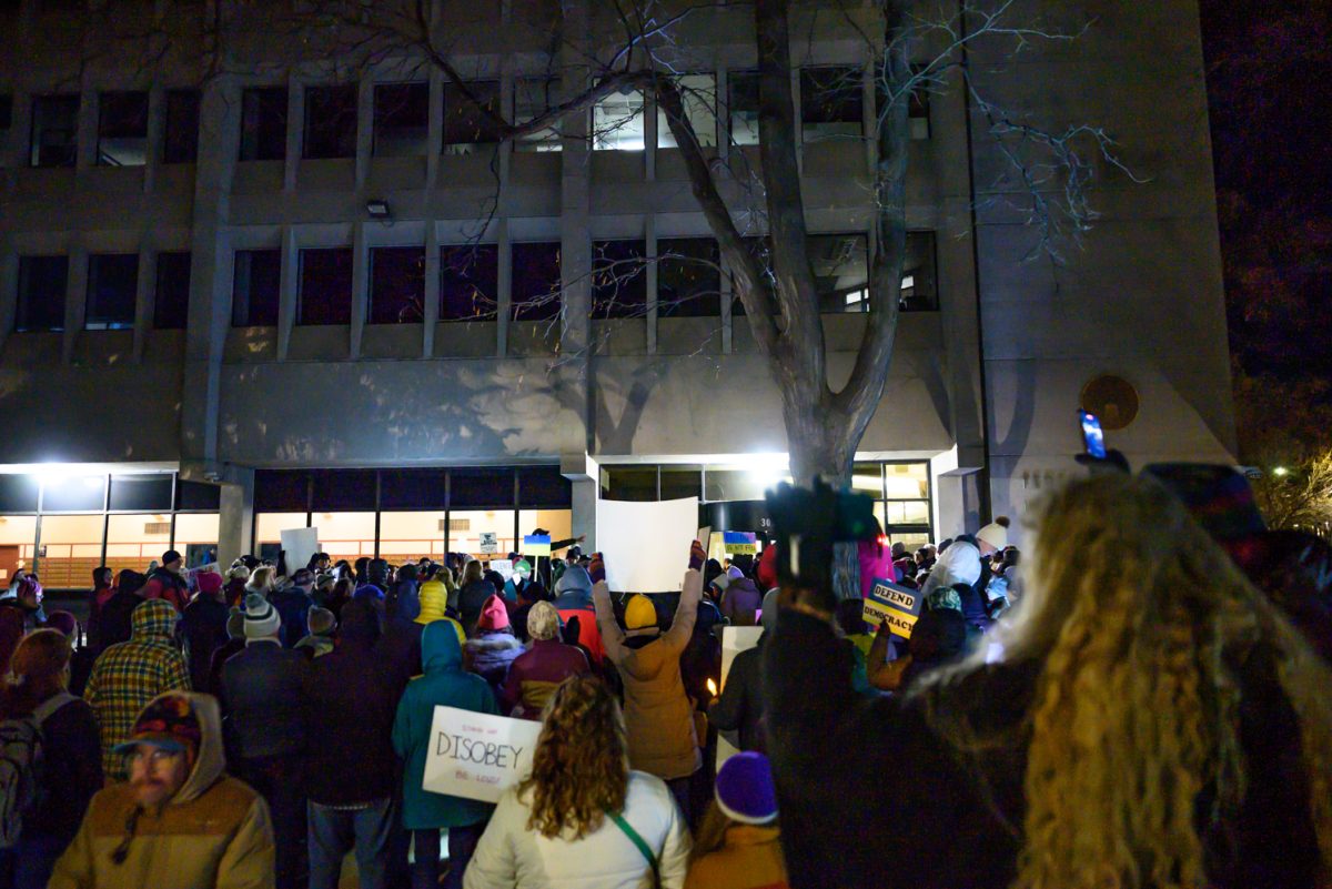 Protesters meet outside the Fort Collins Post Office building with signs, flags and stories to tell March 4. Organized by the League of Women Voters, this protest was held to provide a space for community gathering during the President's address to Congress.