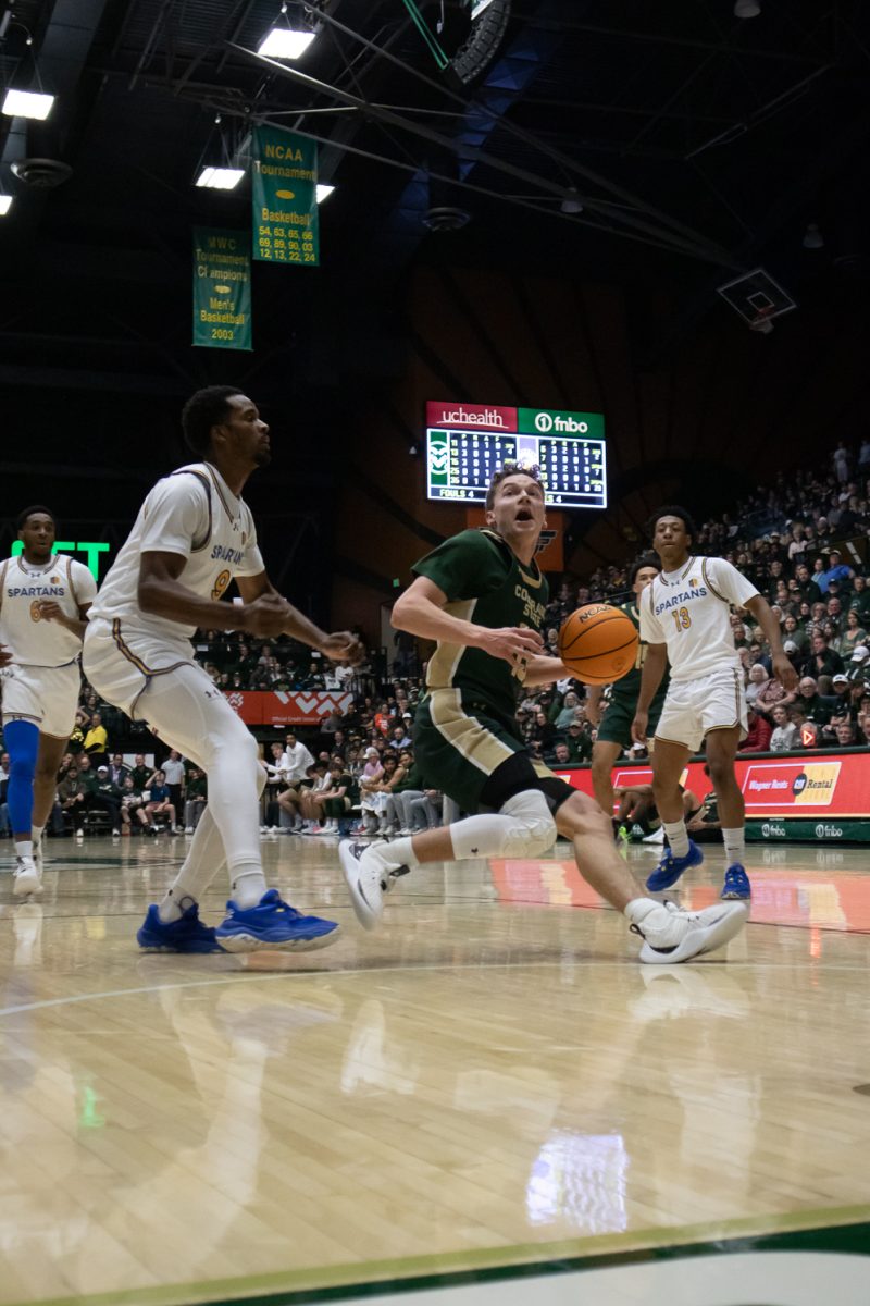 Bowen Born (13) dribbles the ball and looks at the hoop at the Colorado State University game against San Jose State University. CSU won 83-56. Mar.4.
