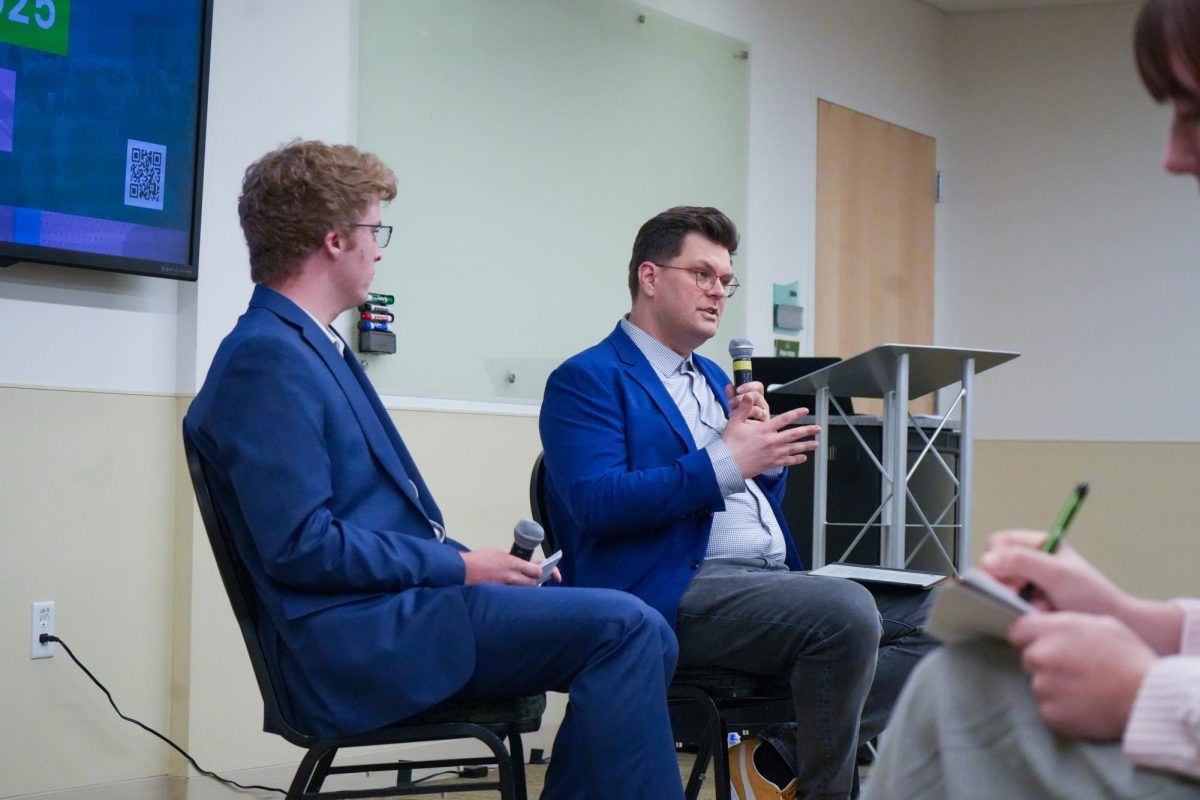 Speaker Dominik Stecula and student moderator Ethan McGuinness address attendees at the Colorado State University Democracy Summit 2025 event titled "Code vs. Consequence: The Tech & Policy Debate on Misinformation and Social Media" March 7.