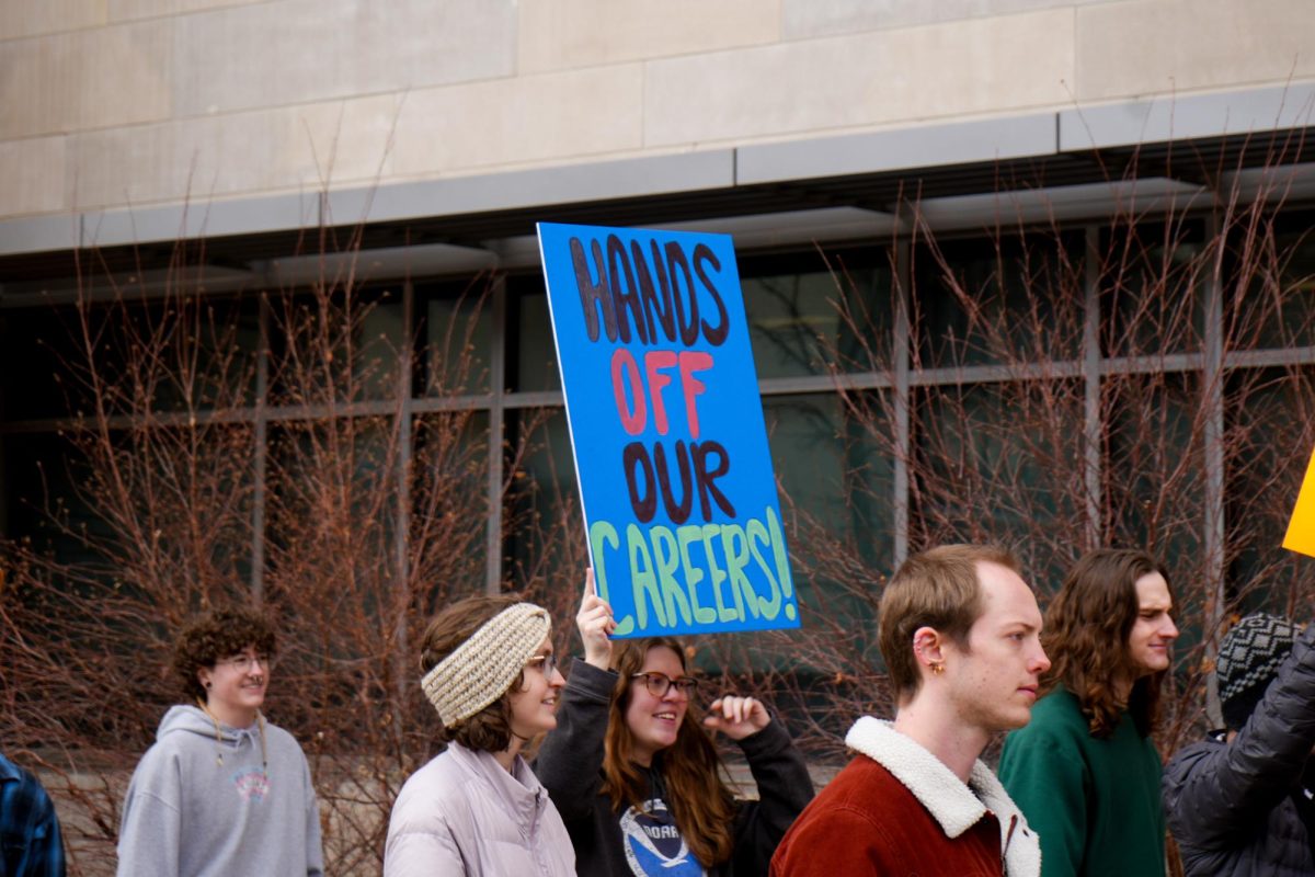 A student holds up a sign that reads "Hands Off Our Careers!" at the Stand up for Science protest March 7. Protesters created signs like these to protest the firing of federal employees in agencies like the U.S. Forest Service, the National Oceanic and Atmospheric Administration and the National Park Service.