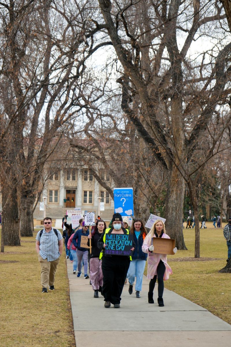 Colorado State University students and faculty and Fort Collins community members walk through The Oval on their way Old Town Square in support of the nationwide Stand Up for Science protest March 7. 