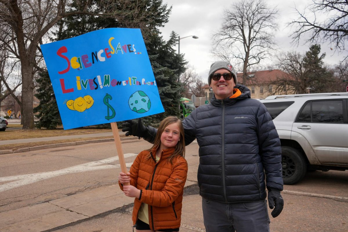 Pearl Stenglein holds up the sign she made in support of the nationwide protest "Stand up for Science" on March 7 2025. 