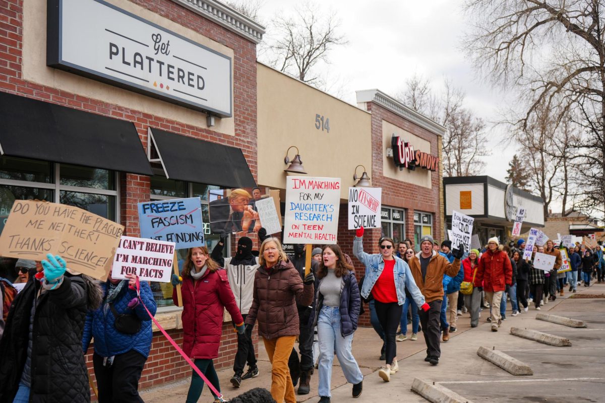 Colorado State University students and faculty and Fort Collins community members make their way to Old Town Square on College Avenue, chanting and cheering in support of the nationwide protest Stand Up for Science March 7. 